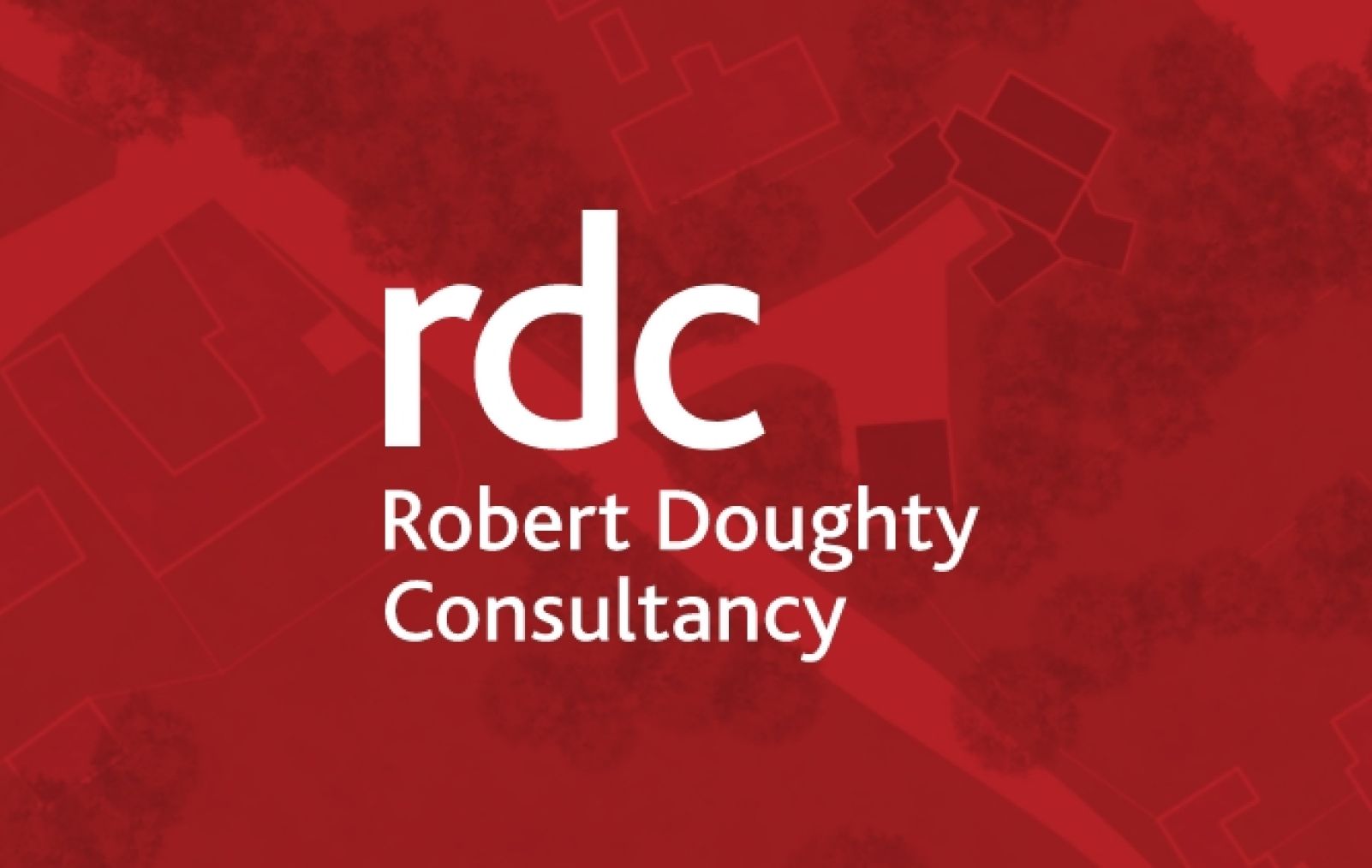 A group of people standing around a table with a land plan